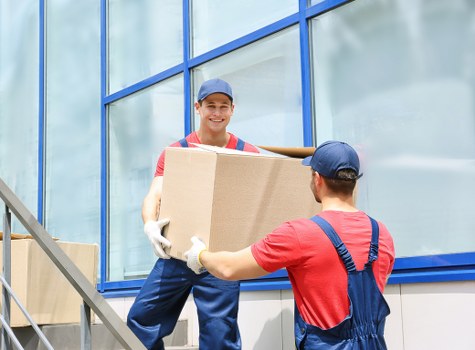 Storage facility staff sorting cardboard and reusable materials for recycling