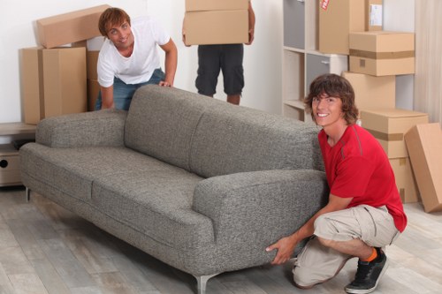 Professional movers loading items into a van in Gantshill
